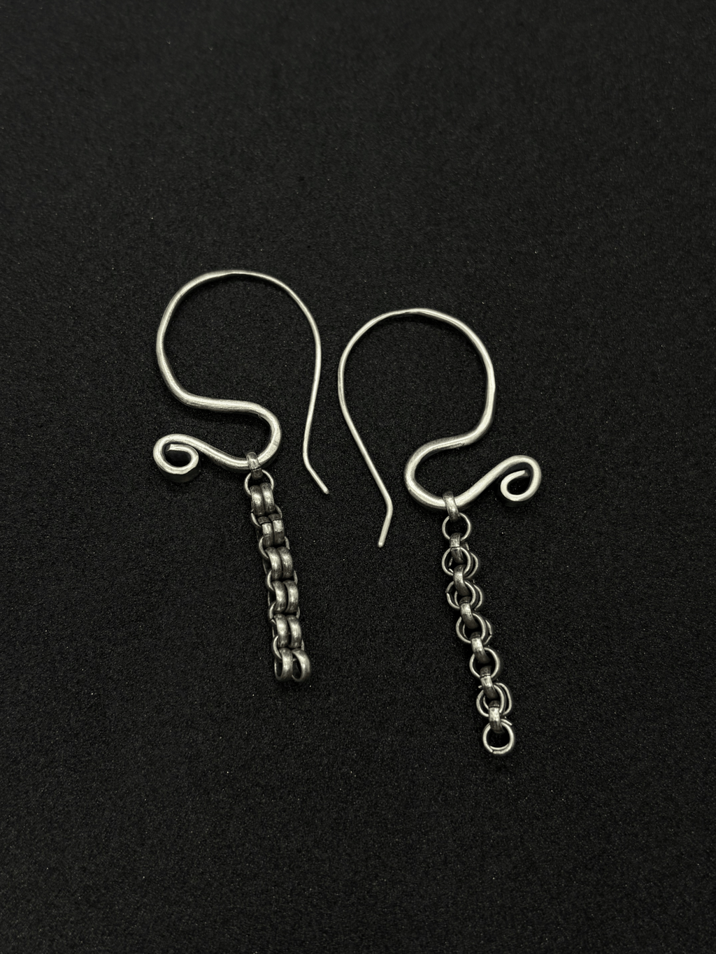 Handcrafted sterling silver Sculptural Motion Earrings with curved hooks and dangling chain links