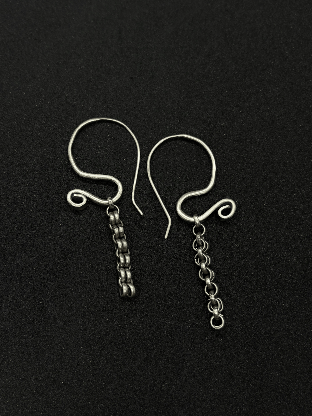 Handcrafted sterling silver Sculptural Motion Earrings with curved hooks and dangling chain links