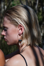 Side view of model wearing the oxidized silver Log Hoop Earring